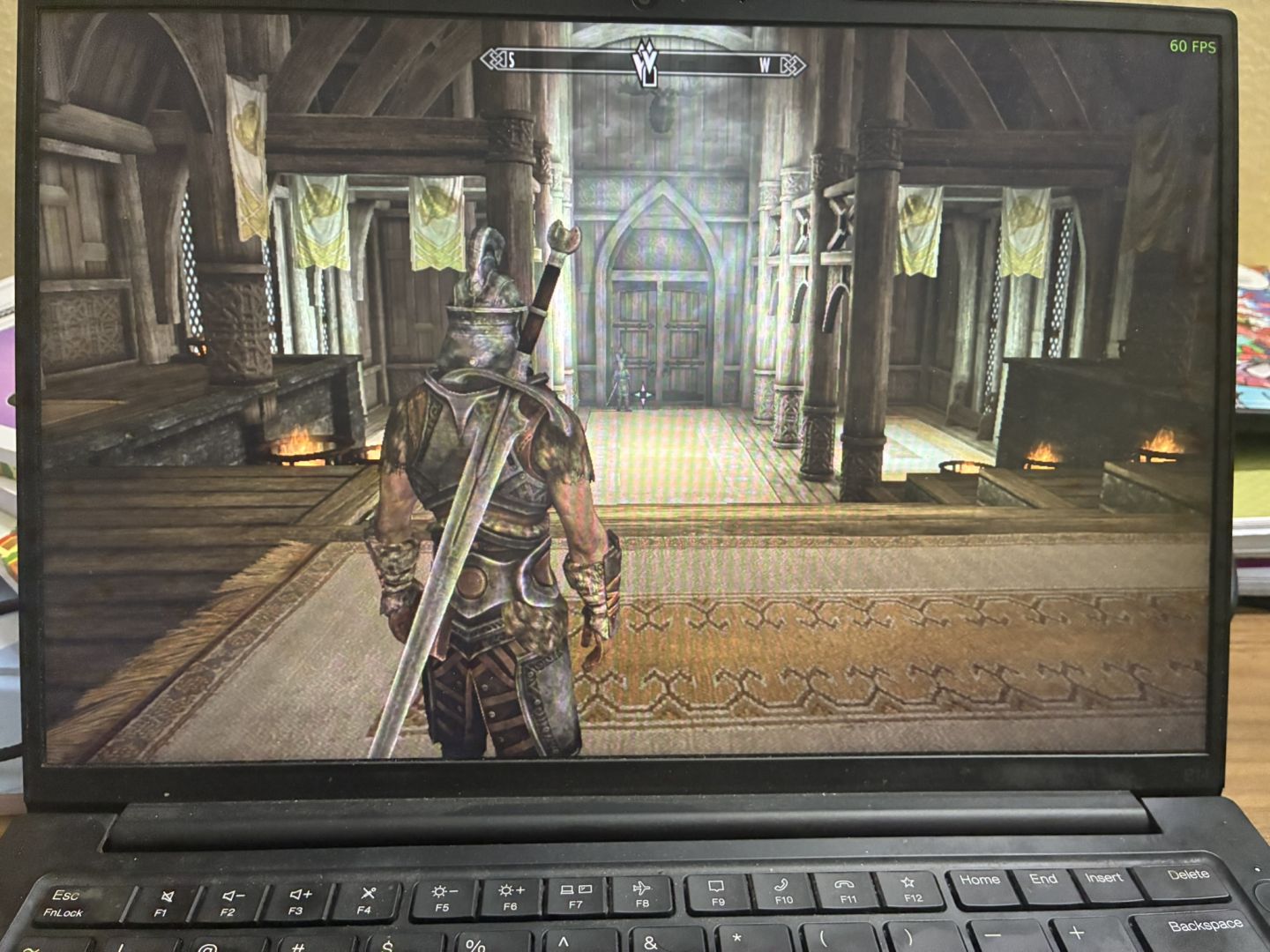 Image of a Thinkpad E14 running Skyrim at 60 fps on Debian 13